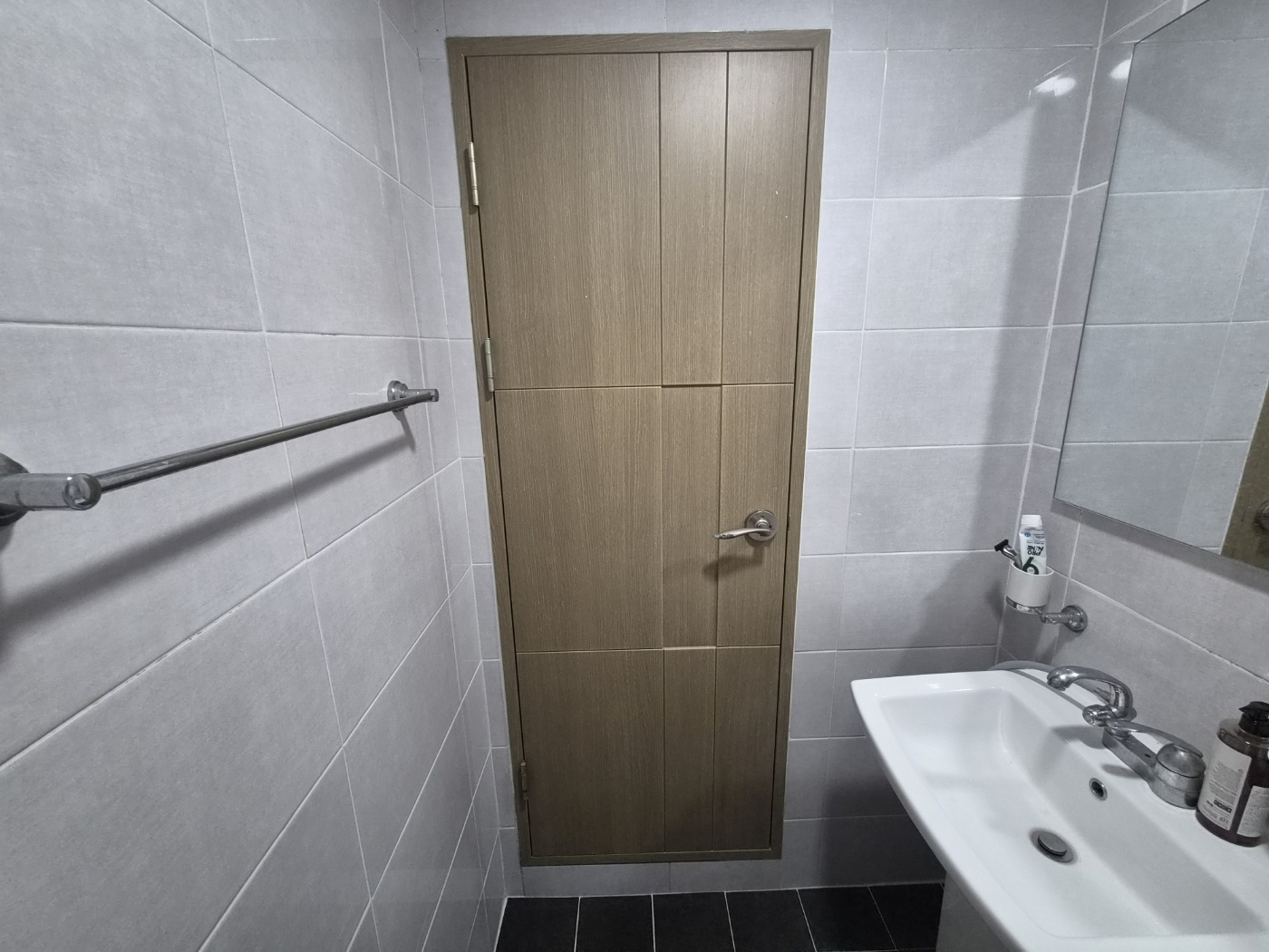The towel bar on the wall next to the bathroom door